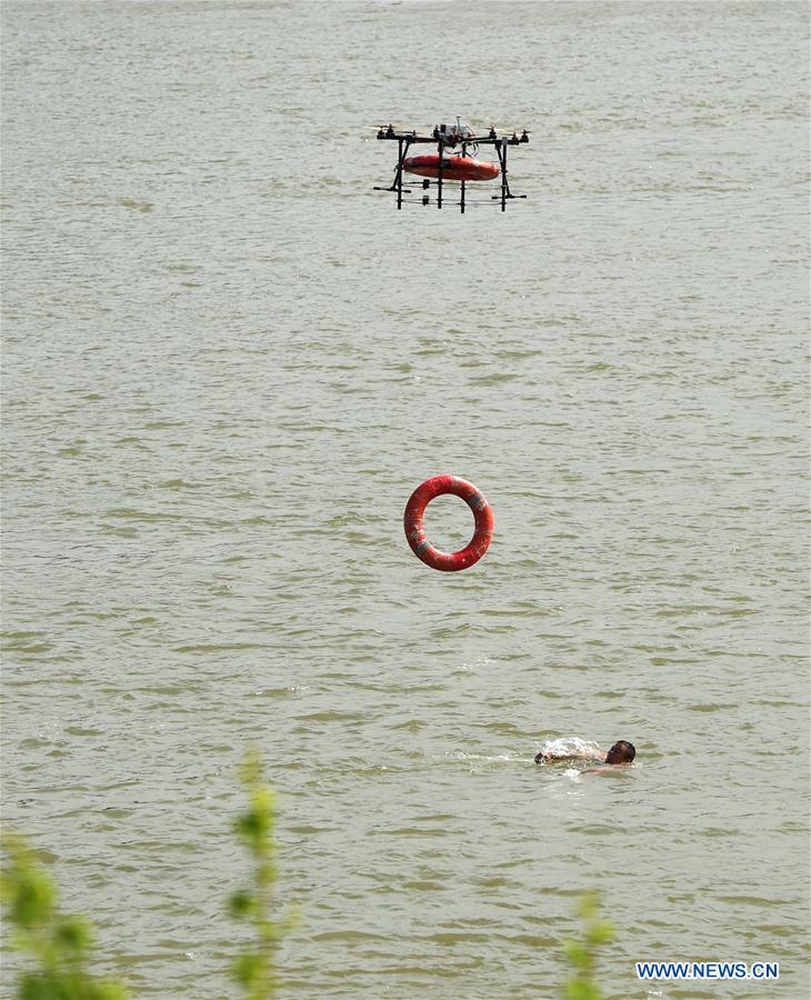 A drone delivers a life buoy to a man in Wuhan, capital of central China's Hubei Province, May 12, 2015. 2015 is the dawn of the drone age. 