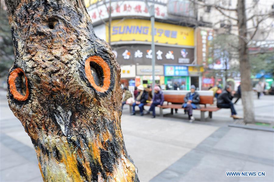 CHONGQING, Jan. 5, 2016 (Xinhua) -- A painted owl stands over a tree along the first street which themed with graffiti arts in southwest China's Chongqing Municipality, Jan. 5, 2016. (Xinhua/Tang Yi) 