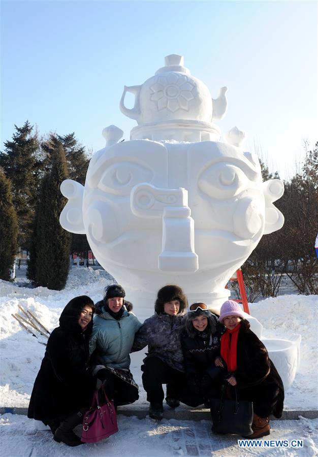 Contestants from Russia pose for photos with their third-prize winning snow sculpture of the 8th International Snow Sculpture Contest for College Students in Harbin, capital of northeast China's Heilongjiang Province, Jan. 7, 2016. 