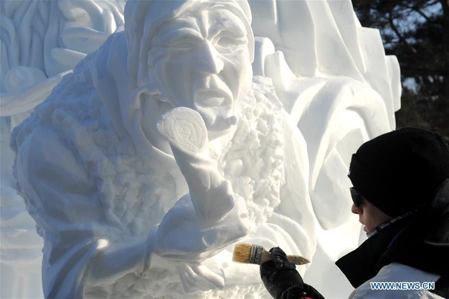 A contestant brushes a snow sculpture during the 8th International Snow Sculpture Contest for College Students in Harbin, capital of northeast China's Heilongjiang Province, Jan. 7, 2016. 