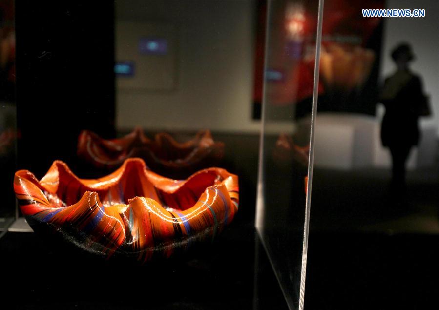 A visitor views the works during an exhibition of glass sculptures by American artist Toots Zynsky in Shanghai, east China, Jan. 12, 2016.