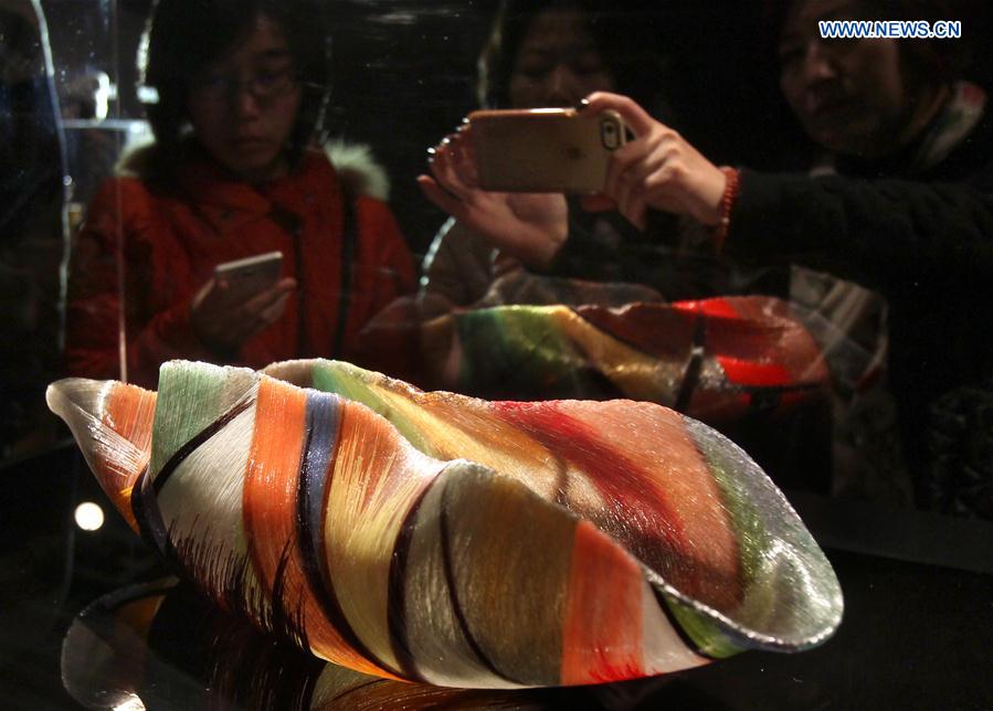 Visitors view a piece of work during an exhibition of glass sculptures by American artist Toots Zynsky in Shanghai, east China, Jan. 12, 2016.