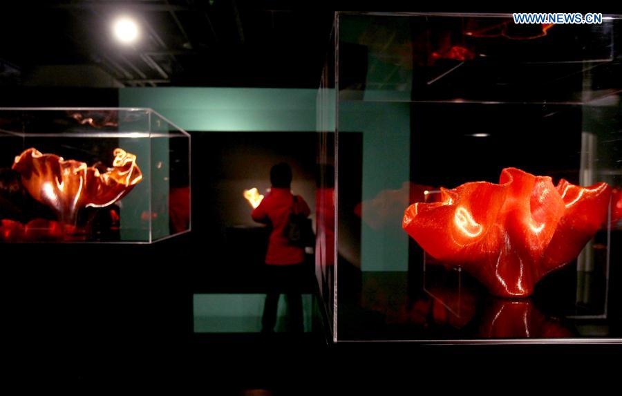 A visitor views the works during an exhibition of glass sculptures by American artist Toots Zynsky in Shanghai, east China, Jan. 12, 2016.