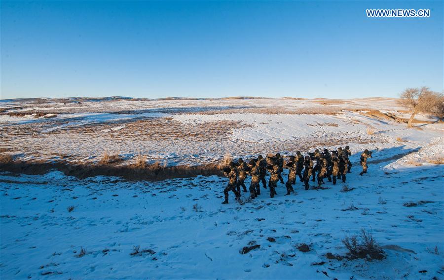 Frontier soldiers take part in a drill under cold weather in Darhan Muminggan United Banner of Baotou City, north China's Inner Mongolia Autonomous Region, Jan. 12, 2016.