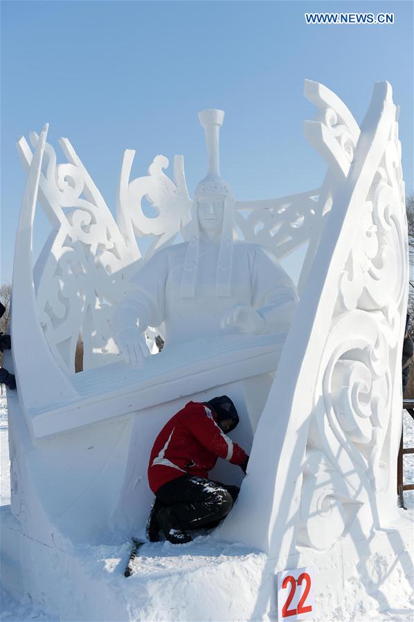 A Mongolian contestant makes a snow sculpture in Harbin, capital of northeast China's Heilongjiang Province, Jan. 13, 2016. 