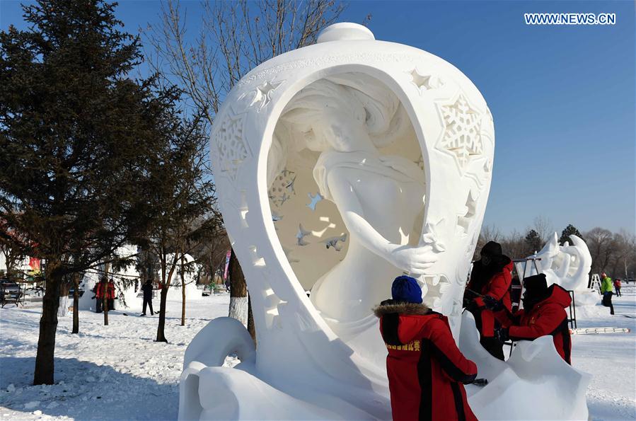 Chinese contestants make a snow sculpture in Harbin, capital of northeast China's Heilongjiang Province, Jan. 13, 2016. 