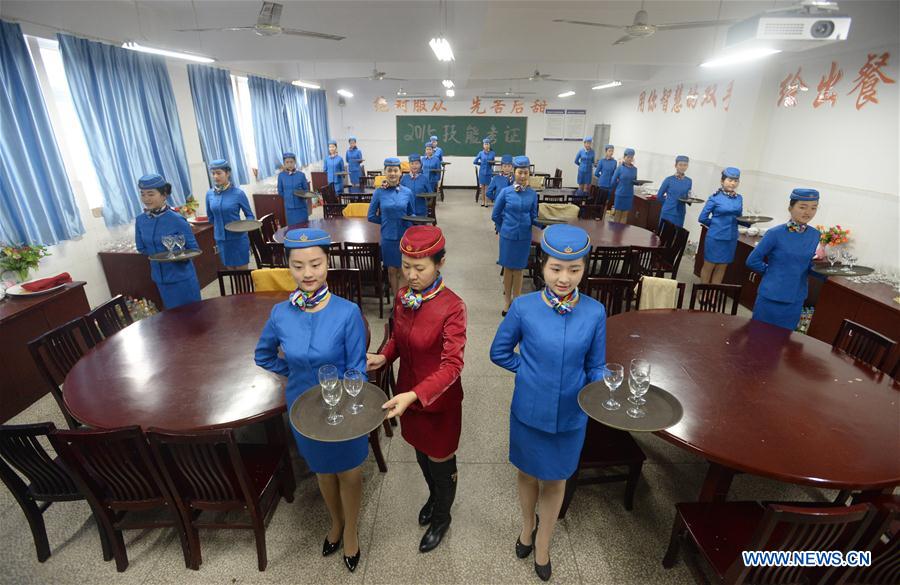 Students take training of catering service at Bishan Vocational Education Center in Chongqing, southwest China, Jan. 13, 2016. 