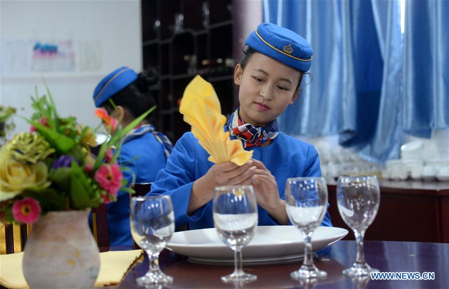 A student takes training of catering service at Bishan Vocational Education Center in Chongqing, southwest China, Jan. 13, 2016. 