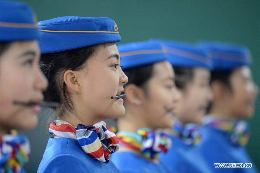 Students hold chopsticks in the mouths to keep smile in training at Bishan Vocational Education Center in Chongqing, southwest China, Jan. 13, 2016. 