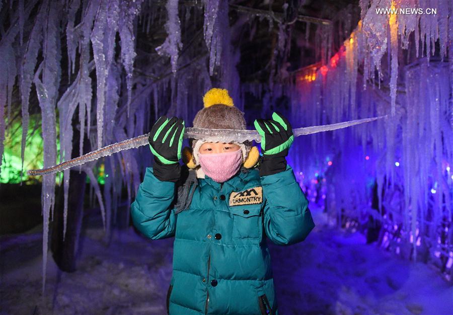 A tourist sightsees in Snow Village resort near Laobai Mountain in Dunhua, northeast China's Jilin Province, Jan. 14, 2016.