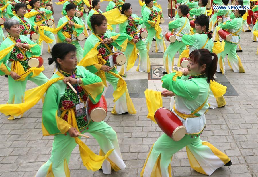 People perform at a square in Xuyi County, east China's Jiangsu Province, Jan. 14, 2016. 