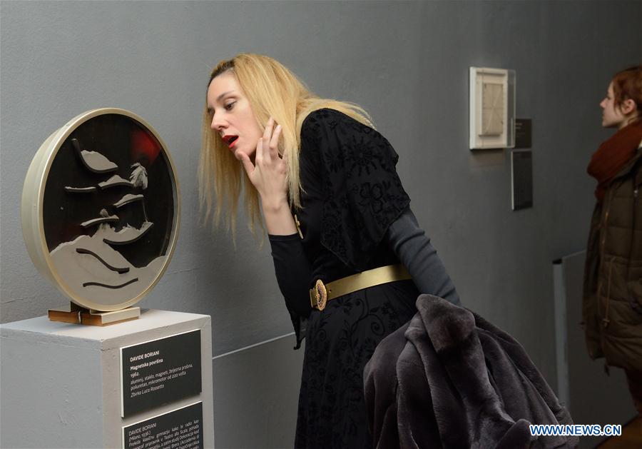 Visitors look at artworks during the opening ceremony of the Moving Eye Exhibition at the Museum of Arts and Crafts in Zagreb, Croatia, Jan. 14, 2016. 