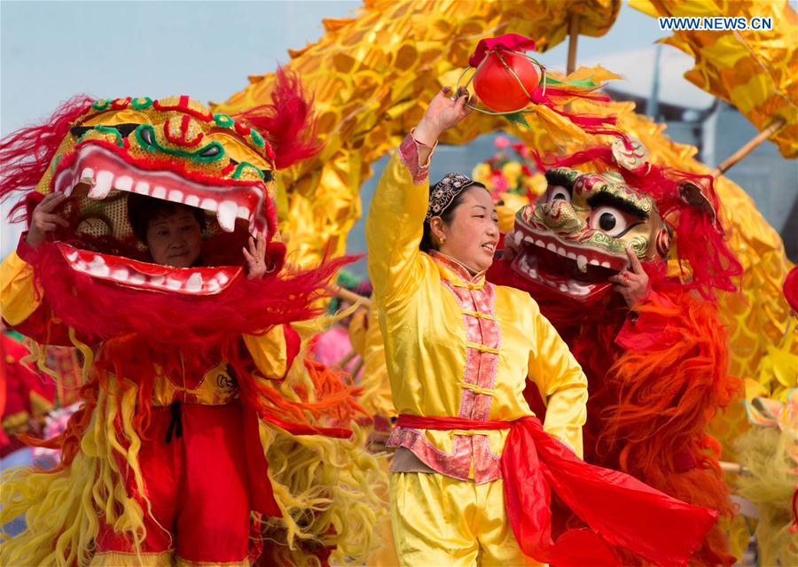 ople perform at a square in Xuyi County, east China's Jiangsu Province, Jan. 14, 2016. 