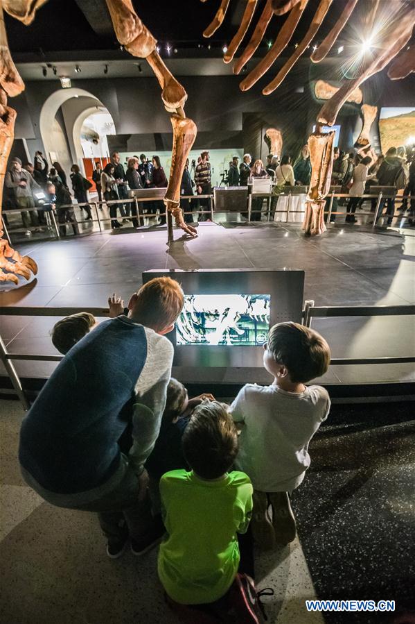 School children look at the 'Titanosaur' skeleton exibition in the American Museum of Natural History in New York, the United States, Jan. 14, 2016. 