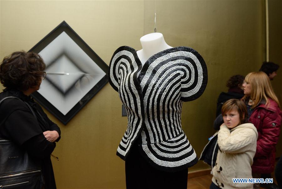 Visitors look at artworks during the opening ceremony of the Moving Eye Exhibition at the Museum of Arts and Crafts in Zagreb, Croatia, Jan. 14, 2016. 