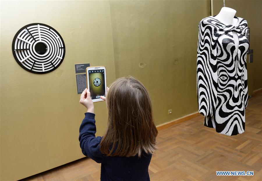 Visitors look at artworks during the opening ceremony of the Moving Eye Exhibition at the Museum of Arts and Crafts in Zagreb, Croatia, Jan. 14, 2016. 