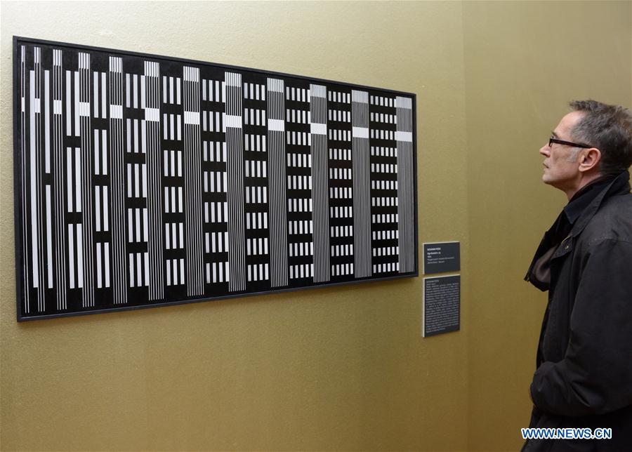 Visitors look at artworks during the opening ceremony of the Moving Eye Exhibition at the Museum of Arts and Crafts in Zagreb, Croatia, Jan. 14, 2016.