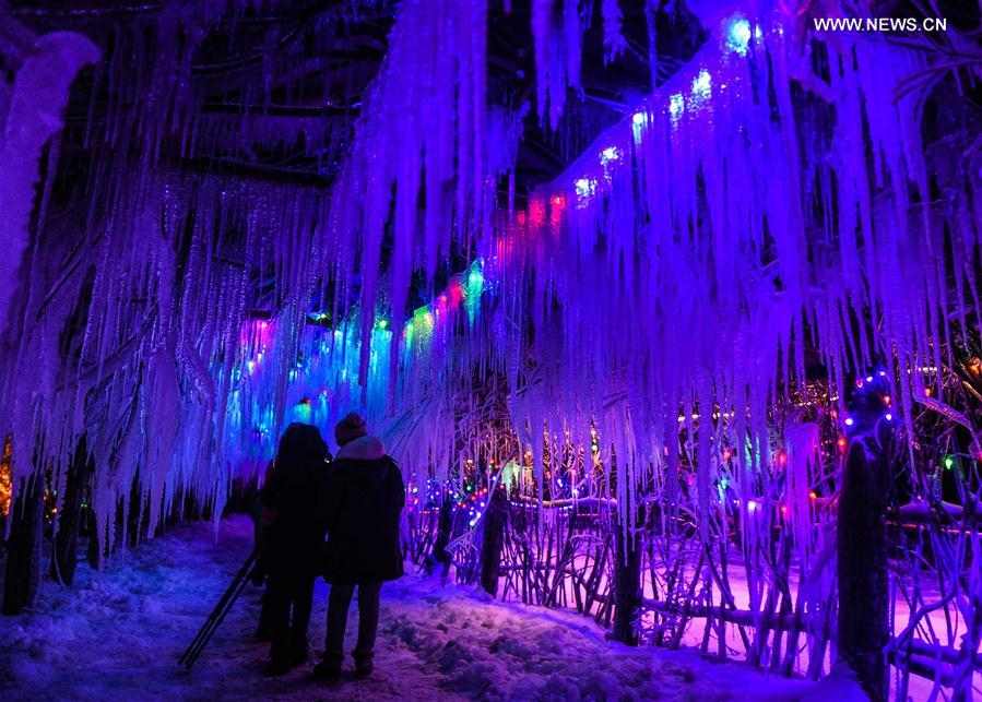 Tourists sightsee in Snow Village resort near Laobai Mountain in Dunhua, northeast China's Jilin Province, Jan. 14, 2016. 