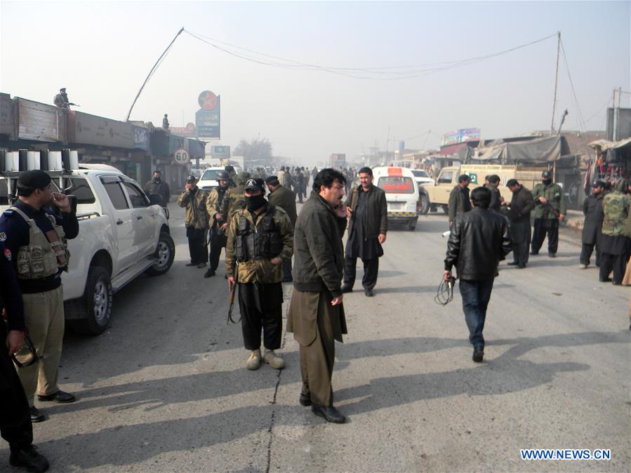 Security officials examine a blast site in Peshawar, Pakistan, Jan. 19, 2016.