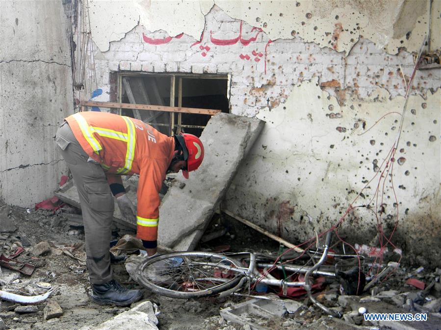 A security official examines a blast site in Peshawar, Pakistan, Jan. 19, 2016. 