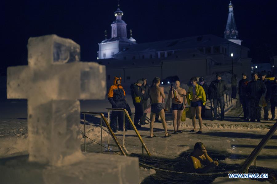 VALDAY, Jan. 19, 2016 (Xinhua) -- A Russian Orthodox believer bathes in the icy water on Epiphany in Valday lake near Iversky monastery with the air temperature at about 10 Celsius degrees below zero, in Valday, Russia, Jan. 19, 2016. Orthodox believers mark Epiphany on Jan. 19 by immersing themselves in icy waters regardless of the weather. The water is blessed by a cleric and considered pure. (Xinhua/Pavel Bednyakov) 