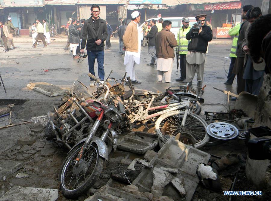 Security officials examine a blast site in Peshawar, Pakistan, Jan. 19, 2016. 