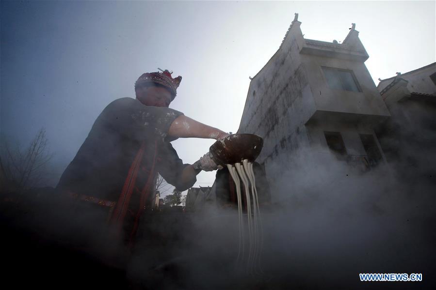 Residents make sweet potato vermicelli at Qingxiang Village of Xinjie Town in Guilin City, a tourist resort in southwest China's Guangxi Zhuang Autonomous Region, Jan. 20, 2016.