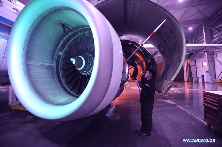 A mechanic checks an aircraft engine at the maintenance base of China Southern Airlines in Haikou, capital of south China's Hainan Province, on Jan. 21, 2016.