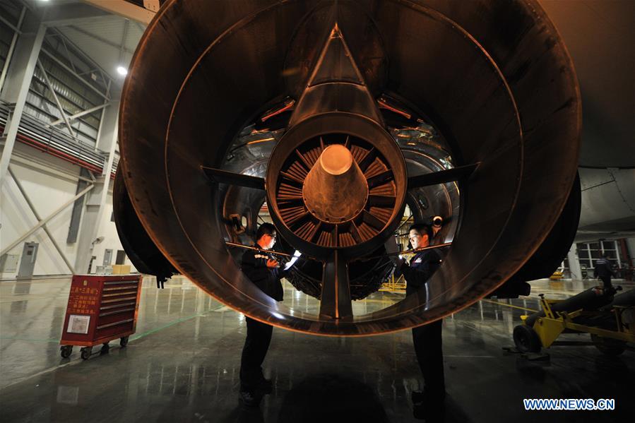 Mechanics check an aircraft engine at the maintenance base of China Southern Airlines in Haikou, capital of south China's Hainan Province, on Jan. 21, 2016.