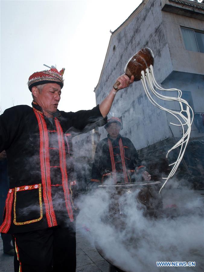 Residents make sweet potato vermicelli at Qingxiang Village of Xinjie Town in Guilin City, a tourist resort in southwest China's Guangxi Zhuang Autonomous Region, Jan. 21, 2016.