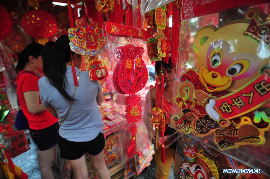 Customers select decorations for Chinese New Year at a market in Jakarta, Indonesia, Jan. 25, 2016. 