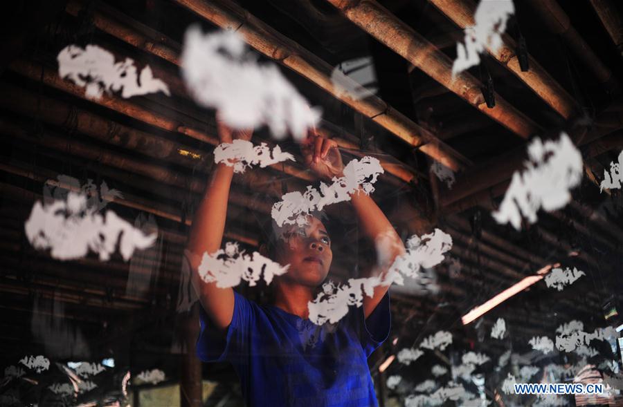 A worker makes candles for the upcoming Chinese Lunar New Year at a traditional candle workshop in Tangerang, Indonesia, Jan. 26, 2016. 