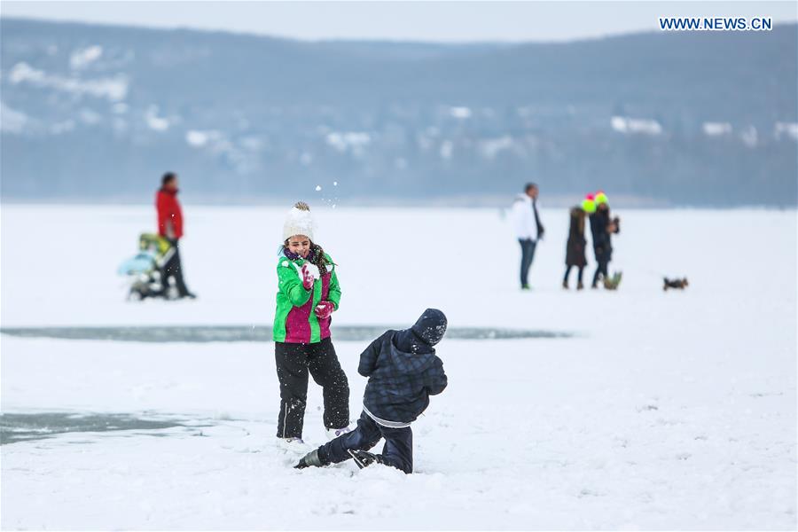 Children have a snowball fight on the frozen Lake Balaton in western Hungary, on Jan. 25, 2016. 
