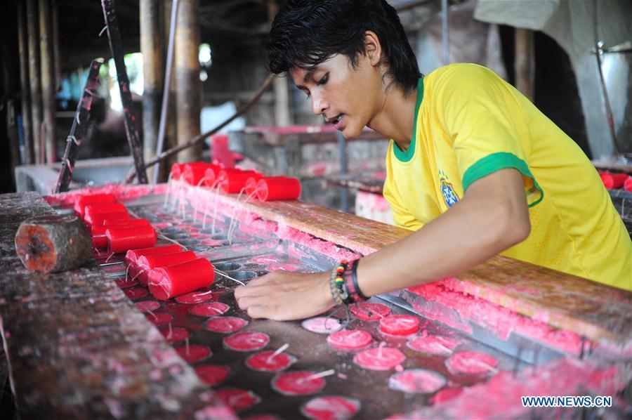 A worker makes candles for the upcoming Chinese Lunar New Year at a traditional candle workshop in Tangerang, Indonesia, Jan. 26, 2016. 