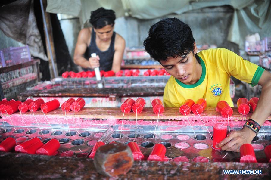 A worker makes candles for the upcoming Chinese Lunar New Year at a traditional candle workshop in Tangerang, Indonesia, Jan. 26, 2016. 