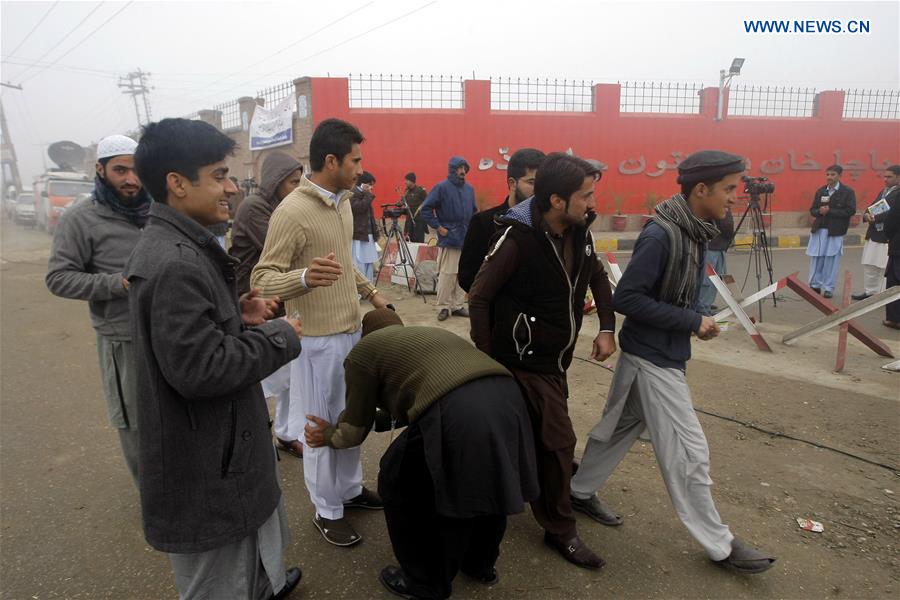 A Pakistani policeman checks students outside the Bacha Khan University in Charsadda, northwest Pakistan, Jan. 25, 2016. 