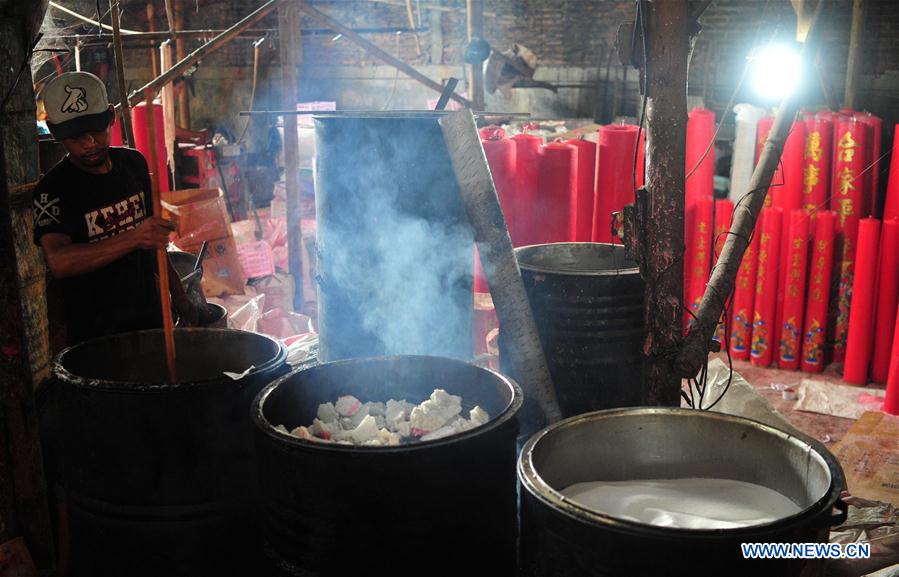 A worker makes candles for the upcoming Chinese Lunar New Year at a traditional candle workshop in Tangerang, Indonesia, Jan. 26, 2016. 