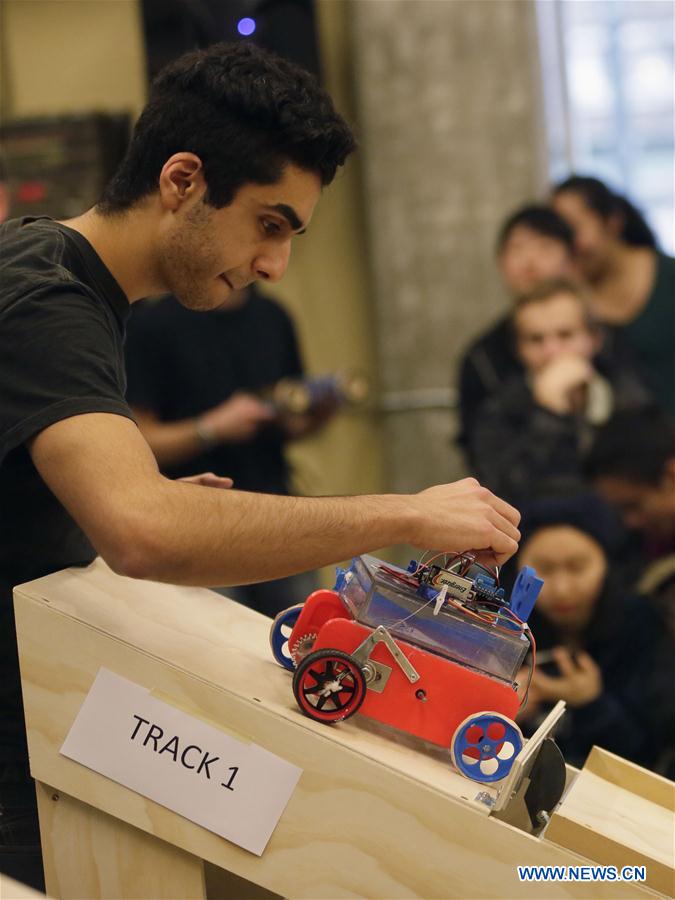 Students adjust their robotic vehicle during a competition at the University of British Columbia in Vancouver, Cananda, Jan. 27, 2016. 