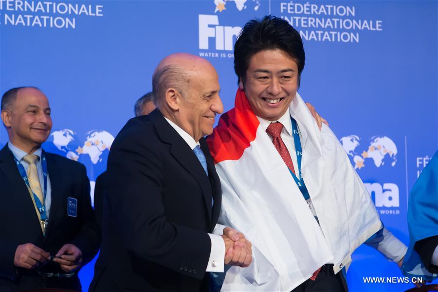 FINA President Julio Maglione (L) announces Japan's Fukuoka as host city of the 2021 World Aquatics Championships at a FINA press conference in Budapest, Hungary, on January 31, 2016