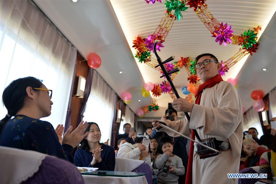 Actors perform on the train Z316, a train heading from Hohhot, capital of north China's Inner Mongolia Autonomous Region, to Beijing, capital of China, to celebrate the Xiaonian Festival, Feb. 1, 2016. 