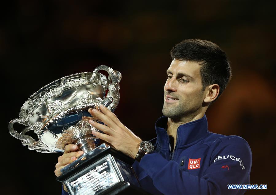 Novak Djokovic of Serbia poses with the trophy after winning the final of men's singles against Andy Murray of Great Britain at the Australian Open Tennis Championships in Melbourne, Australia, Jan. 31, 2016. Novak Djokovic won the match 6-1, 7-5, 7-6.
