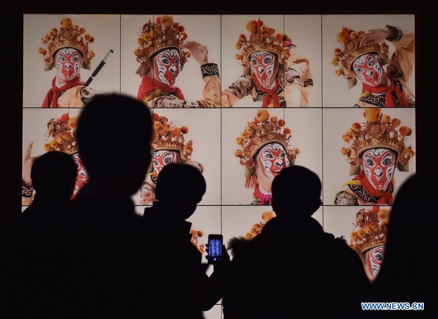 Visitors view pictures at the Capital Museum in Beijing, capital of China, Feb. 1, 2016.