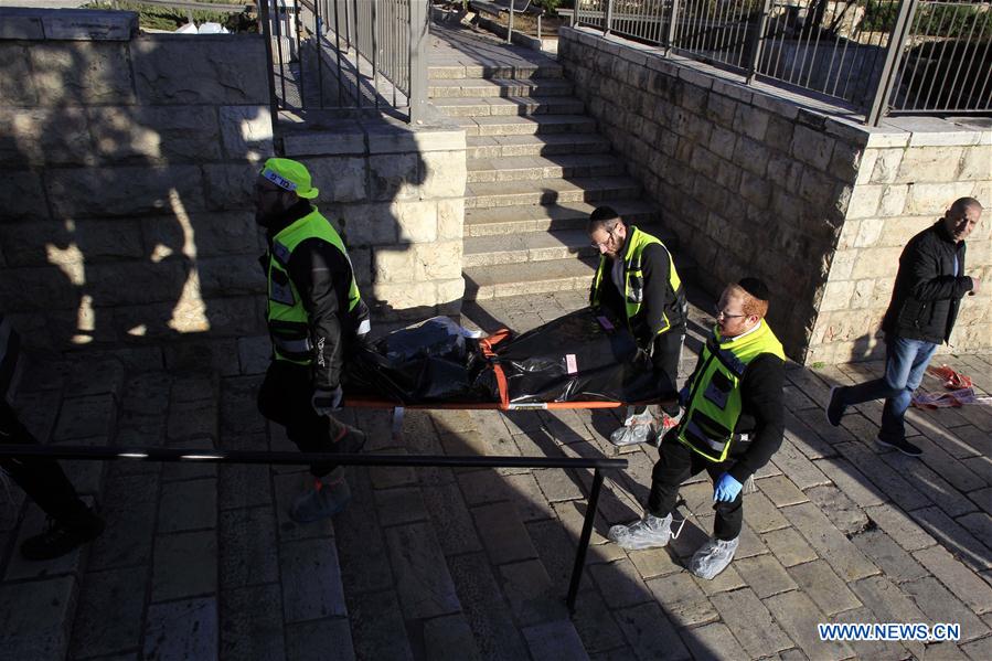 Israeli police officers inspect the bodies of the reported Palestinian assailants who were killed following an attack at Damascus Gate, a main entrance to Jerusalem's Old City, Feb. 3, 2016.