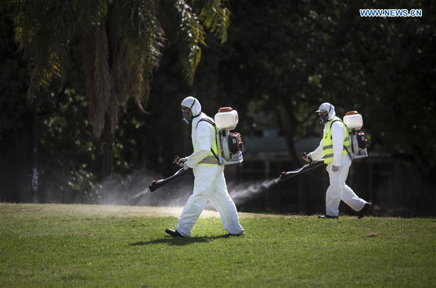 Argentina's Environment and Public Space Ministry fumigation brigade members spay insecticide in an area of Saavedra Park, in an effort to control the Aedes aegypti mosquito, in Buenos Aires, capital of Argentina, on Feb. 11, 2016. 