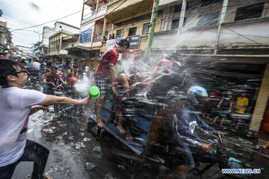 People splash water during celebrations of the Chinese Lunar New Year in Riau, Indonesia, Feb. 11, 2016.