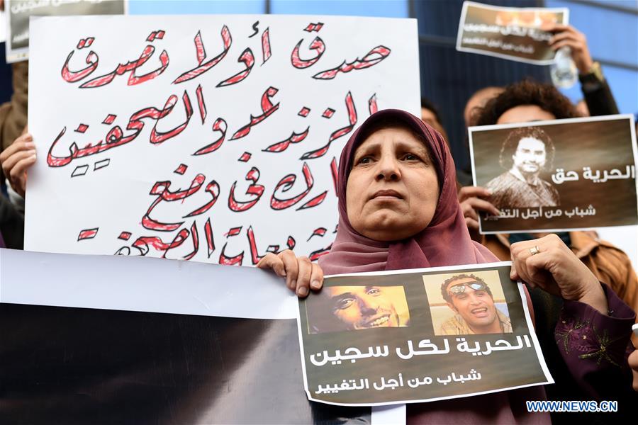 Protesters hold posters during a protest demanding the release of journalists arrested by police in front of the Syndicate of Journalists in Cairo, Egypt on Feb. 11, 2016. 