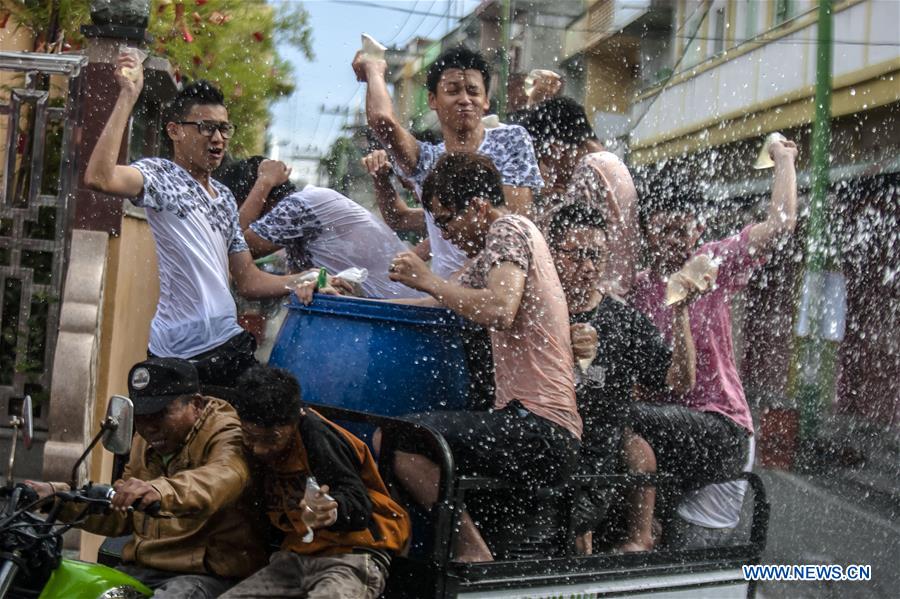 People splash water during celebrations of the Chinese Lunar New Year in Riau, Indonesia, Feb. 11, 2016.