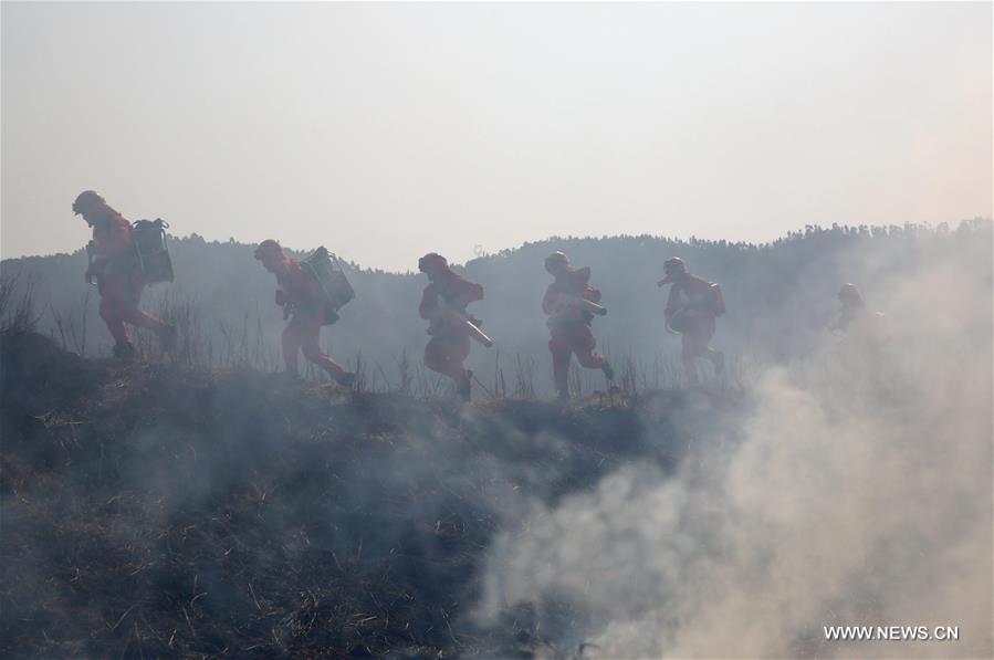 Soldiers take part in a fire drill at a forest zone in Xixiang Township, Xichang City of southwest China's Sichuan Province, Feb. 16, 2016. 