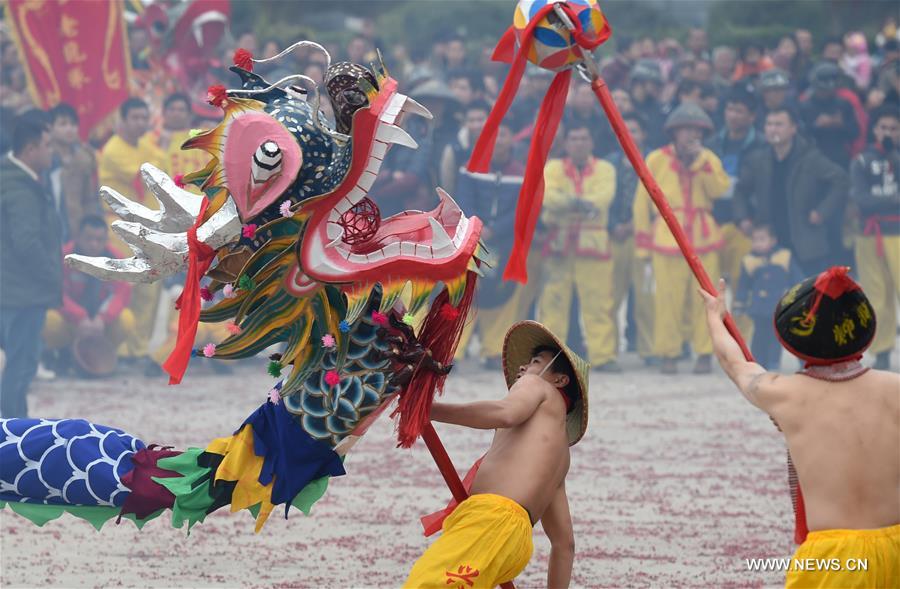 The Binyang-style dance is a derivative of traditional dragon dance in which performers hold dragon on poles and walk through floods of firecrackers.