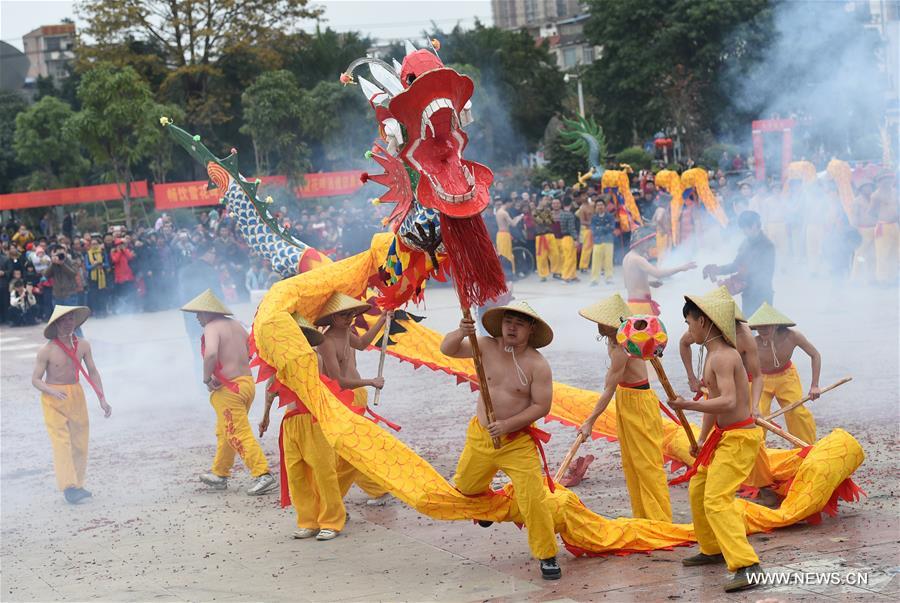 The Binyang-style dance is a derivative of traditional dragon dance in which performers hold dragon on poles and walk through floods of firecrackers.